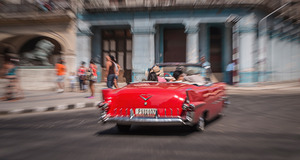 Red Classic Car in Motion