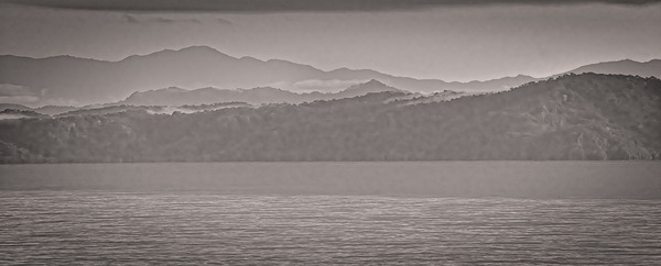 Mountain Silhouettes Over Still Water Print