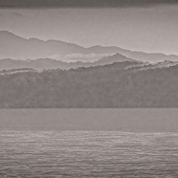 Mountain Silhouettes Over Still Water