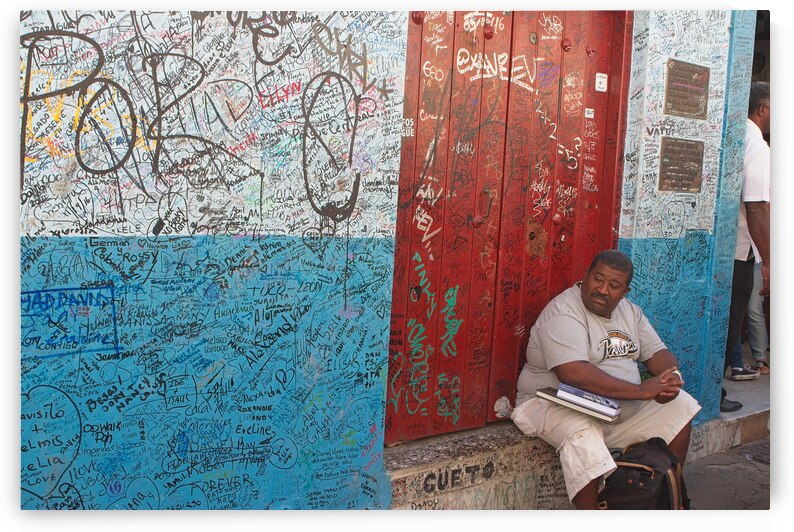 Graffiti-Covered Wall with Seated Man by Chirag Pandya