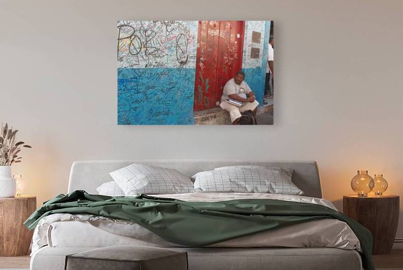 Graffiti-Covered Wall with Seated Man by Chirag Pandya